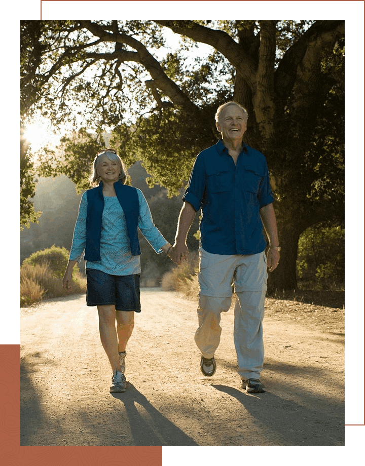 Mature couple walking down dirt road