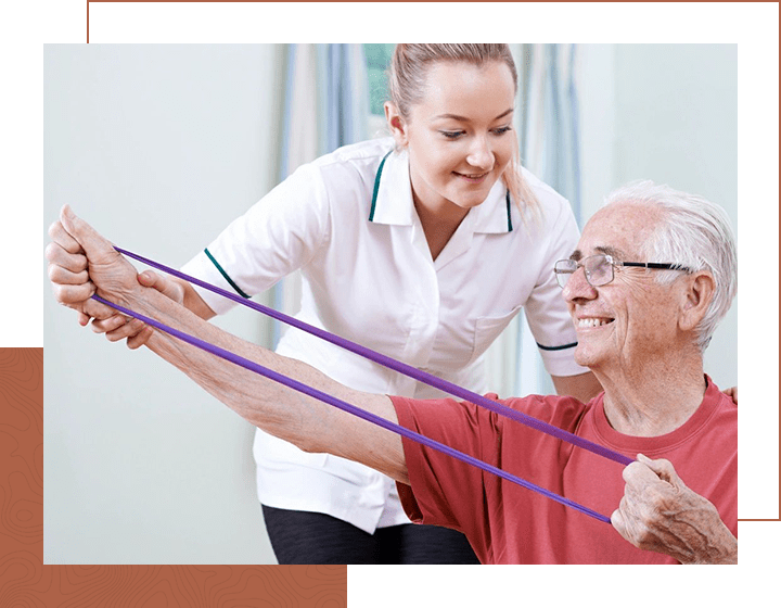 Physiotherapist Helping Senior Male To Use Resistance Band