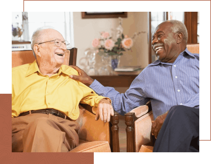 Senior men relaxing in armchairs and laughing together